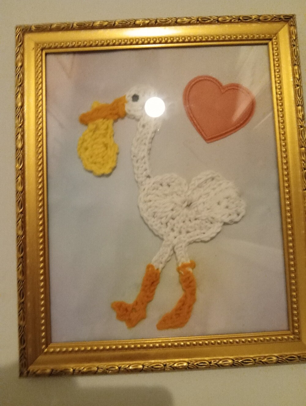 Crocheted White Stork Delivering A Baby Wall Art with Orange Accents